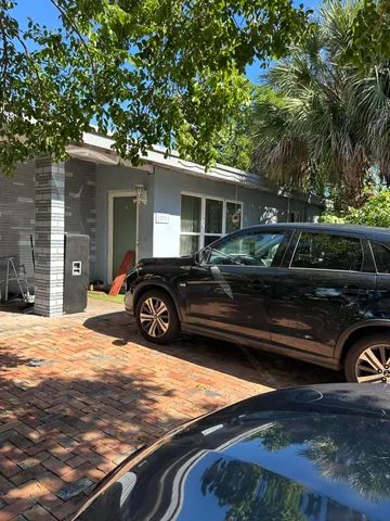a view of a car parked in front of a house