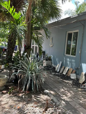 a view of a backyard with potted plants
