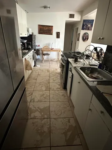 a kitchen with stainless steel appliances a sink stove and refrigerator