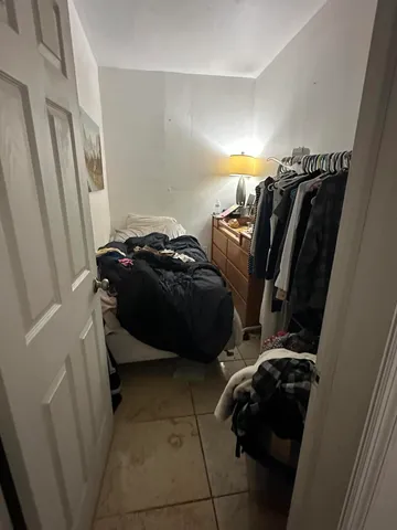 a bedroom with a bed and a closet