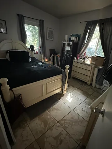 a bedroom with a bed and a flat tv screen