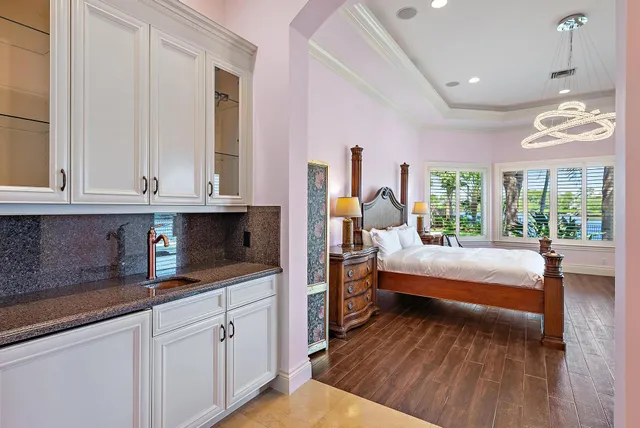 a dining room with wooden floor and a book shelf