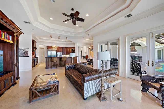 a spacious bathroom with a granite countertop double vanity sink a mirror and a bathtub