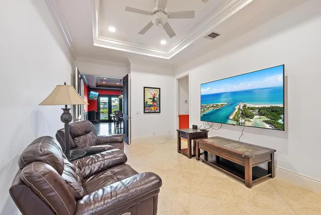 a living room with furniture floor to ceiling window and wooden floor