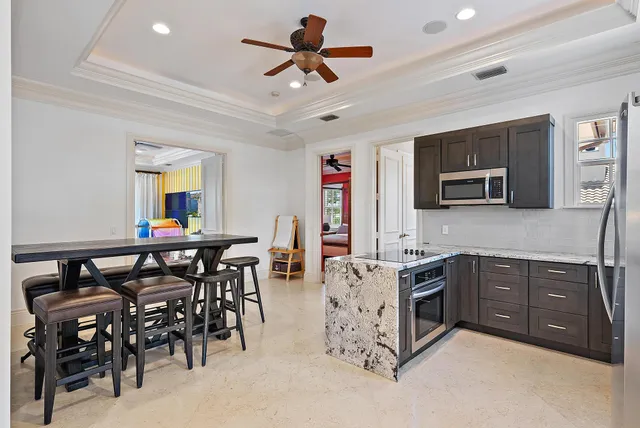 a front view of a house with a yard and palm tree
