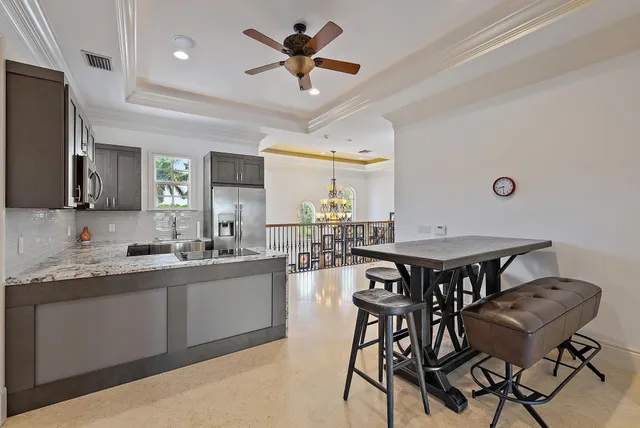 a front view of a house with a garden and tree