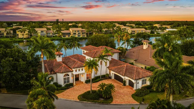 an aerial view of residential houses with outdoor space and swimming pool