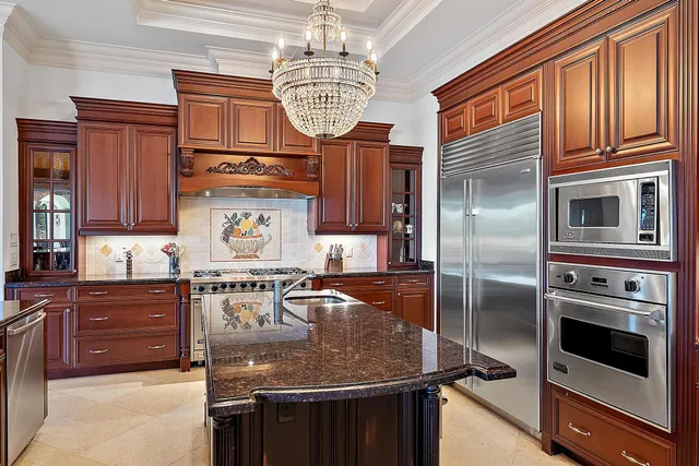 a kitchen with stainless steel appliances granite countertop a stove and a sink