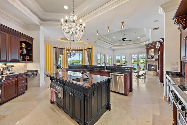 a kitchen with stainless steel appliances granite countertop a refrigerator and a stove