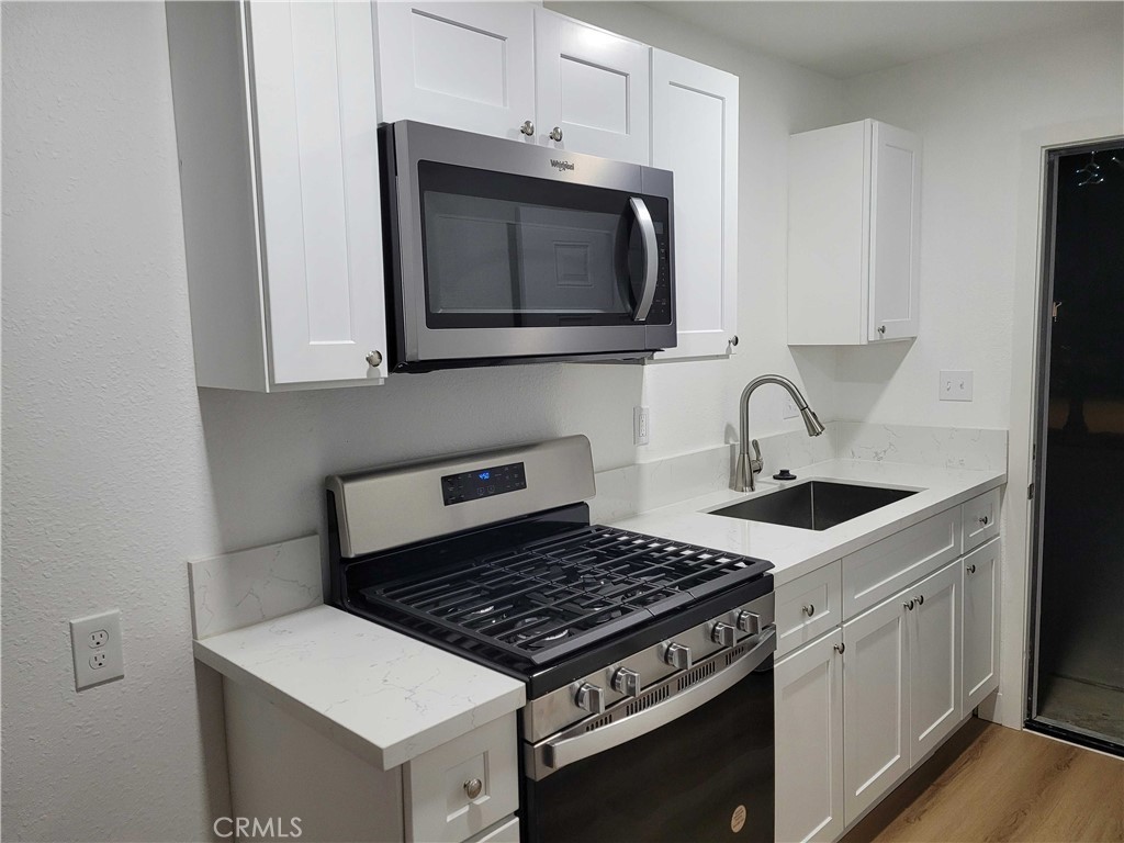 4738 Trebor Road Riverside, CA 92503 - Photo 1 of 10 a kitchen with a stove and a microwave