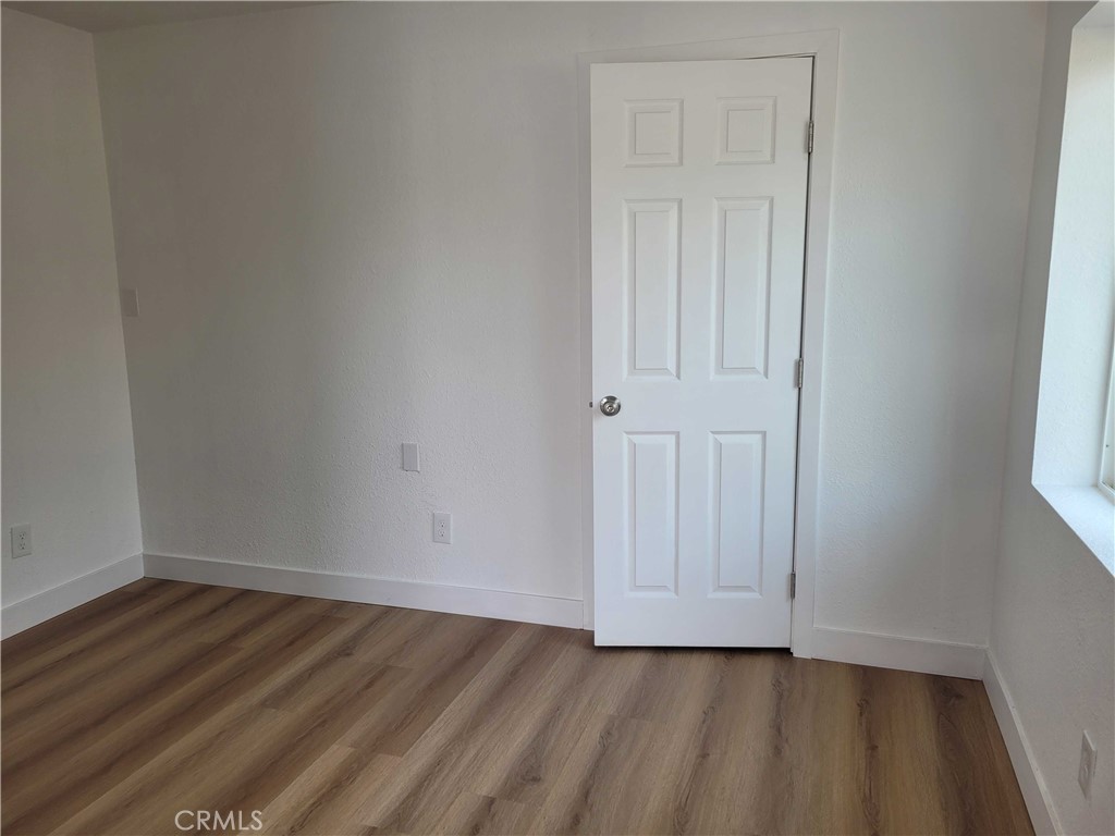 4738 Trebor Road Riverside, CA 92503 - Photo 3 of 10 a view of an empty room with wooden floor