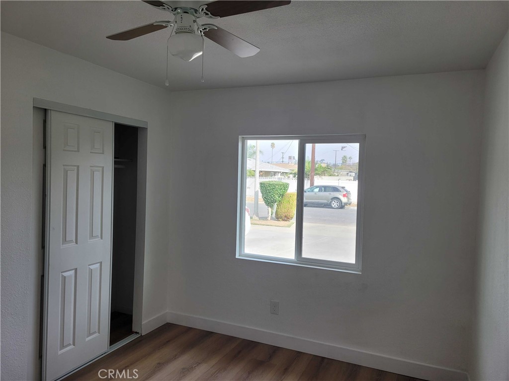 4738 Trebor Road Riverside, CA 92503 - Photo 5 of 10 an empty room with wooden floor and windows