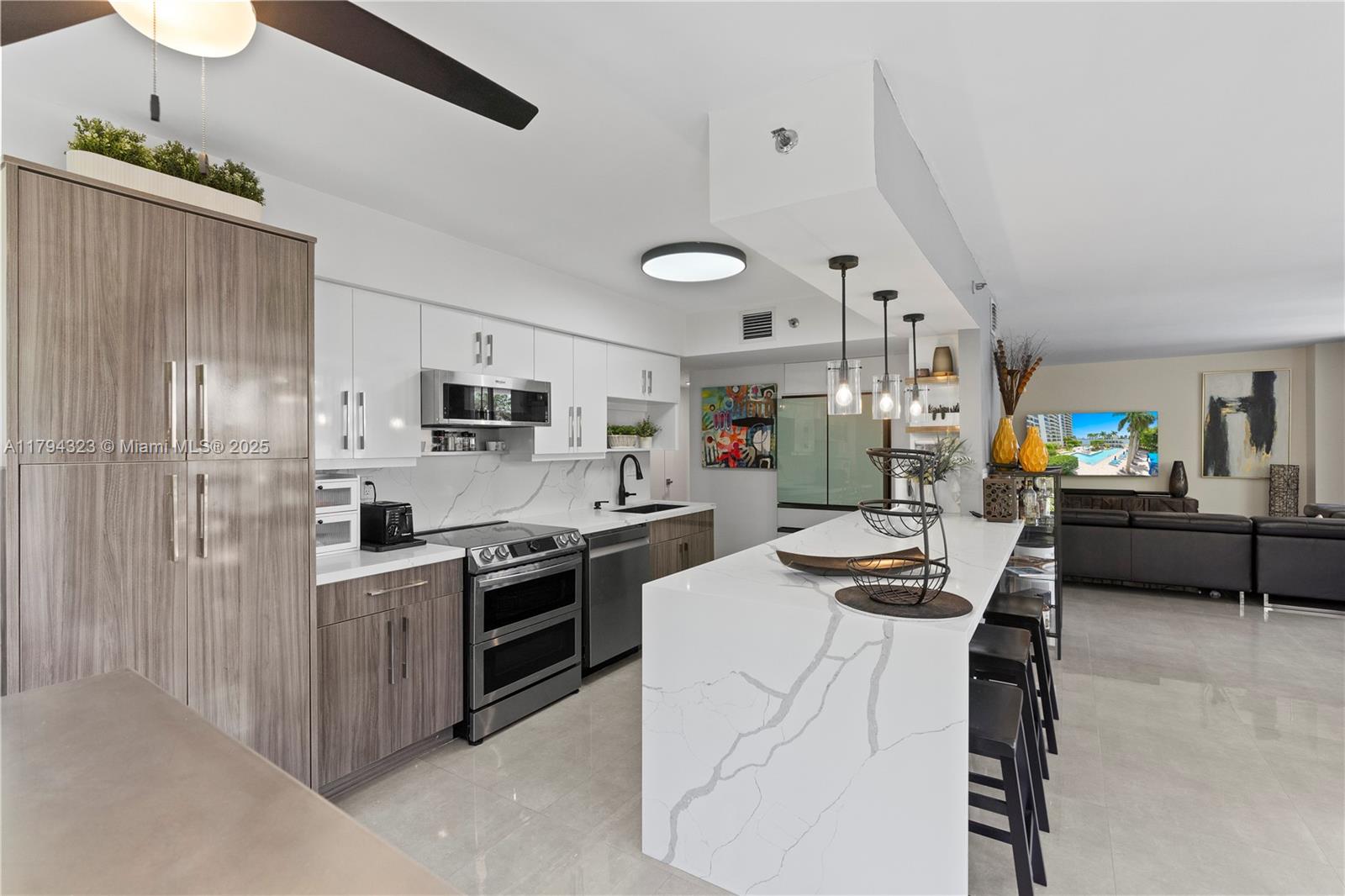 a kitchen with stainless steel appliances kitchen island granite countertop a sink stove and refrigerator
