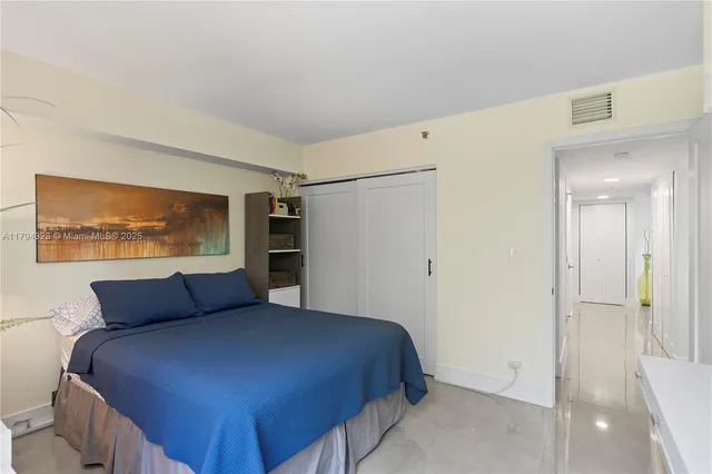 a bedroom with a bed and cabinet