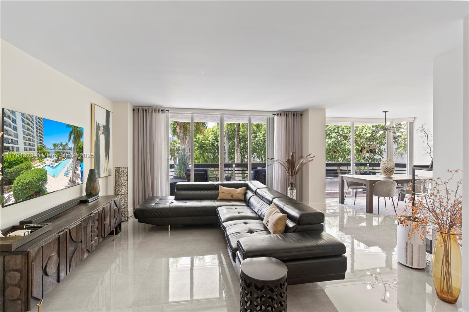 3600 Mystic Pointe Drive, Unit 306 Aventura, FL 33180 - Photo 14 of 52 a living room with furniture and a flat screen tv