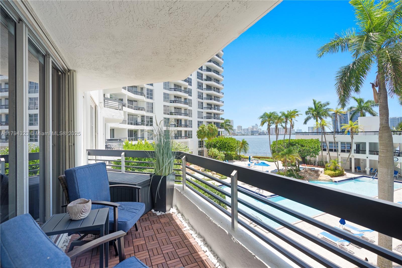 3600 Mystic Pointe Drive, Unit 306 Aventura, FL 33180 - Photo 17 of 52 a view of a balcony with chairs and a potted plant