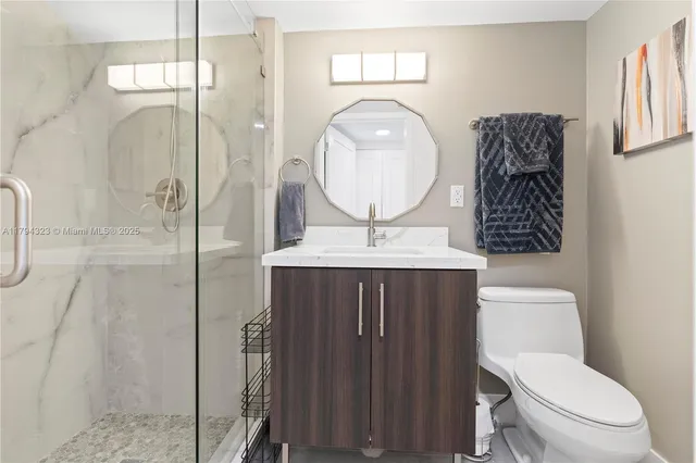 a bathroom with a toilet a sink and mirror