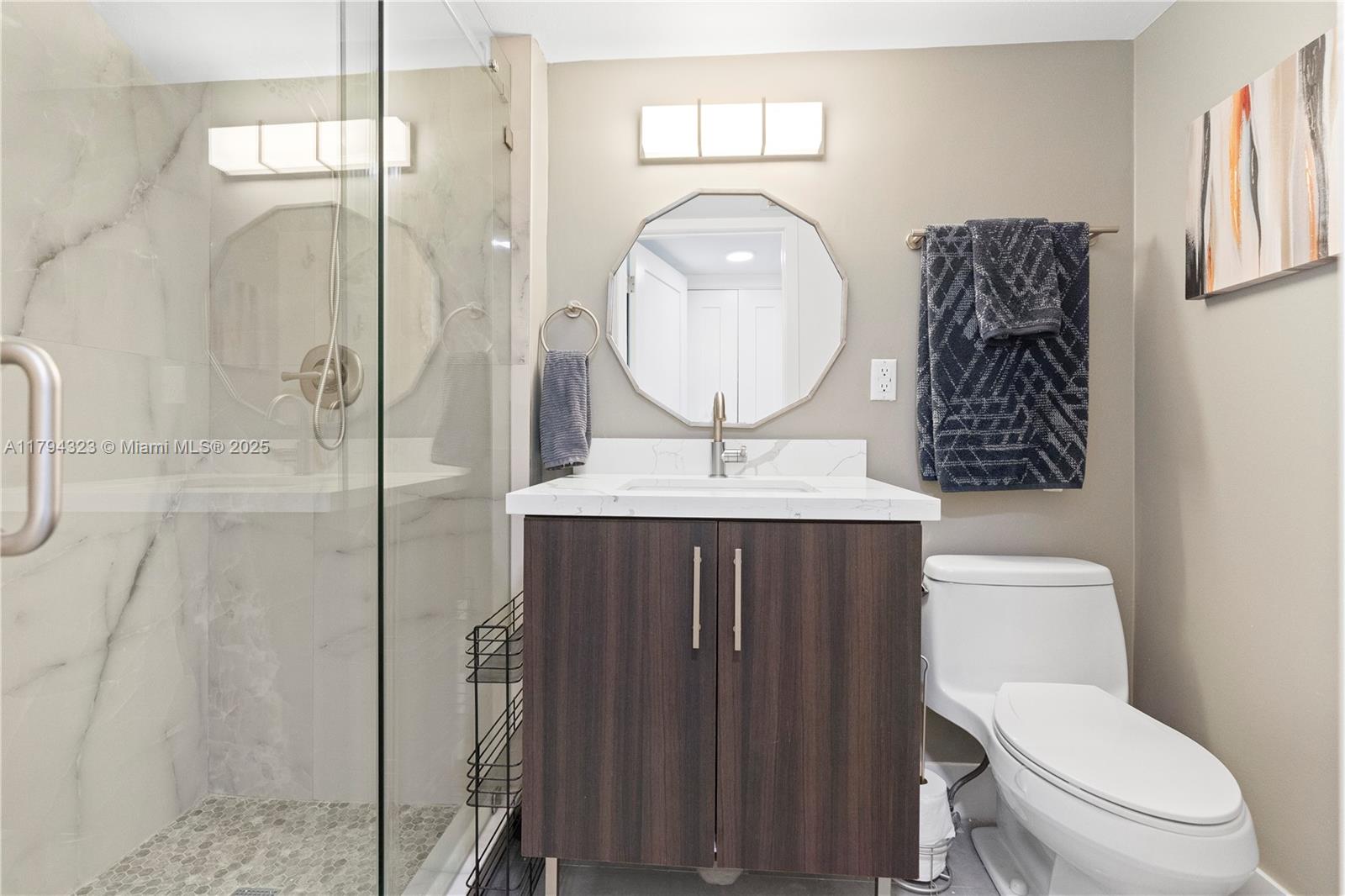 3600 Mystic Pointe Drive, Unit 306 Aventura, FL 33180 - Photo 19 of 52 a bathroom with a toilet a sink and mirror