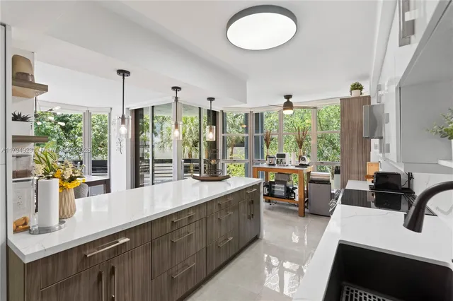 a large kitchen with a large window and counter space