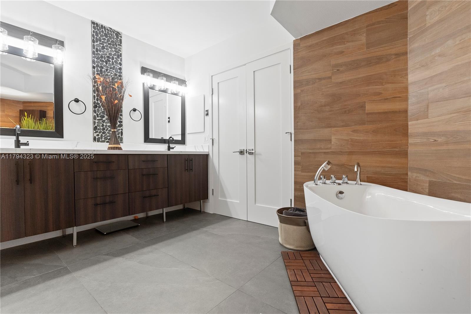 3600 Mystic Pointe Drive, Unit 306 Aventura, FL 33180 - Photo 8 of 52 a bathroom with a tub sink and mirror