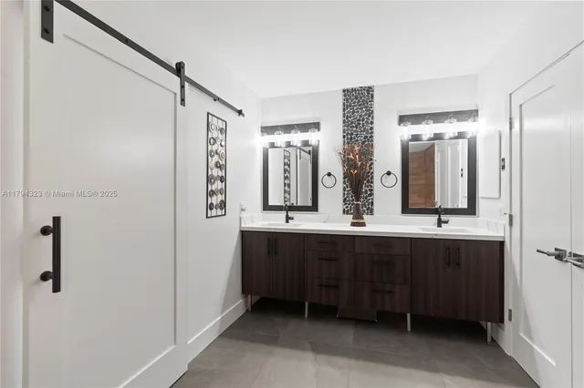 a bathroom with a double vanity sink and mirror