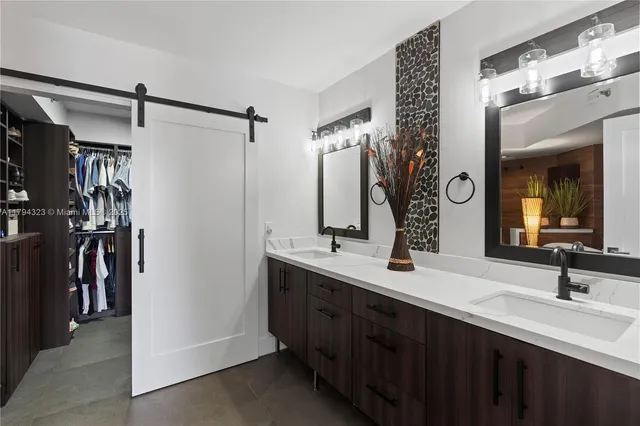 a bathroom with a double vanity sink and a mirror