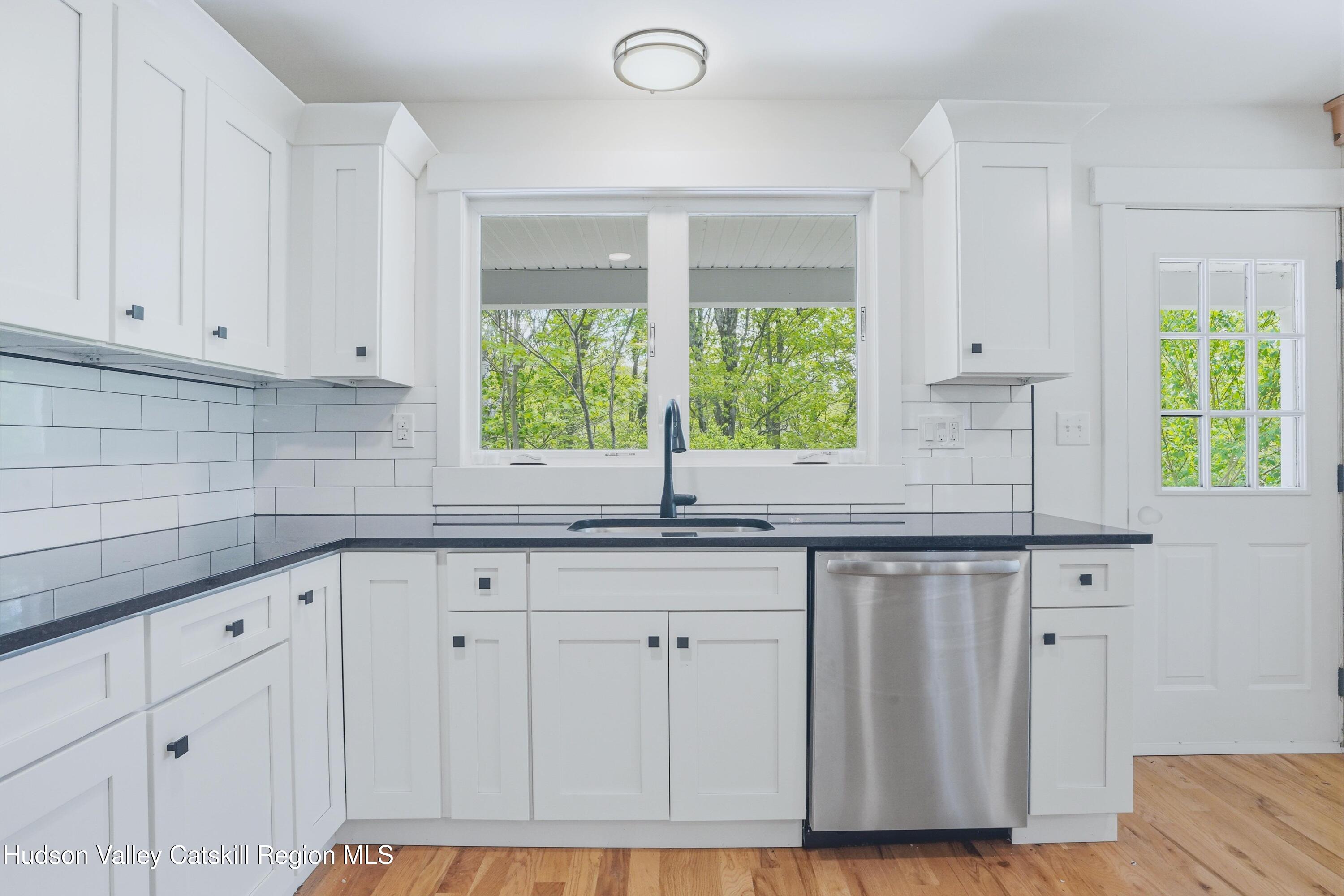 757 Taborton Road Sand Lake, NY 12153 - Photo 10 of 32 a kitchen with granite countertop white cabinets and window