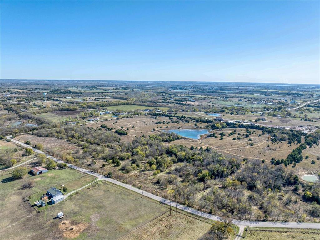 an aerial view of field and trees