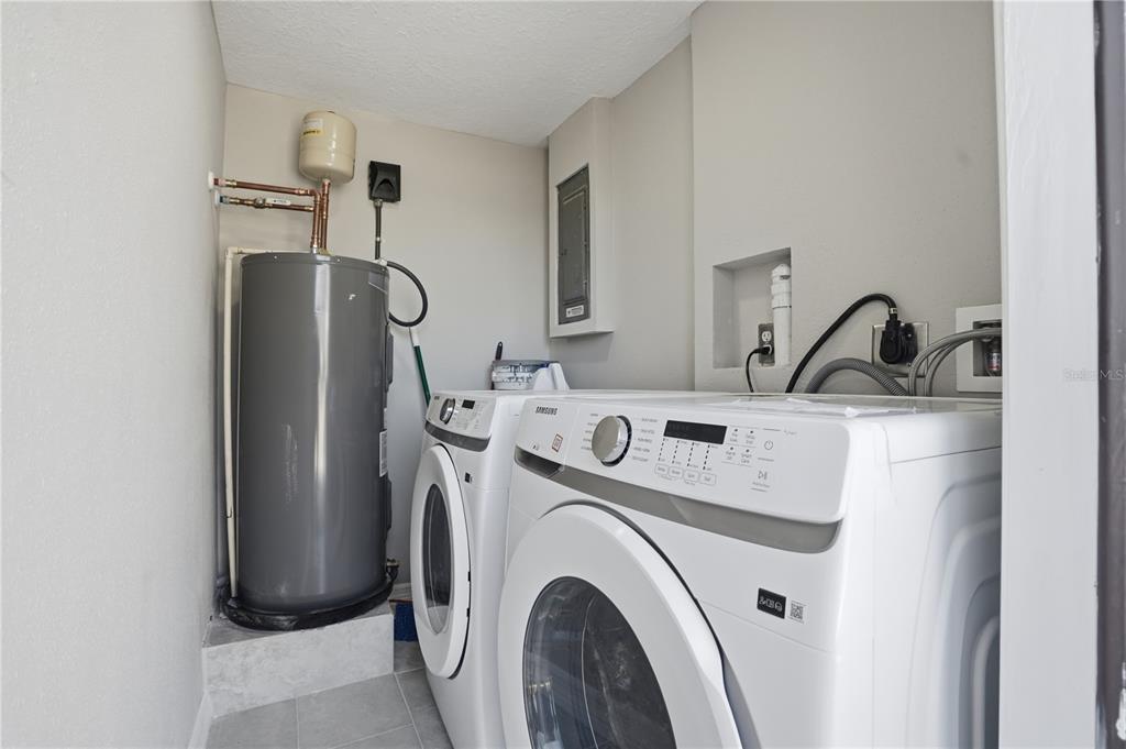 5543 Quist Drive Port Richey, FL 34668 - Photo 16 of 21 a view of storage and utility room with washer and dryer
