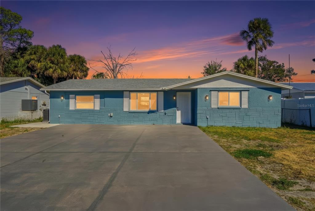 5543 Quist Drive Port Richey, FL 34668 - Photo 20 of 21 a front view of a house with a yard