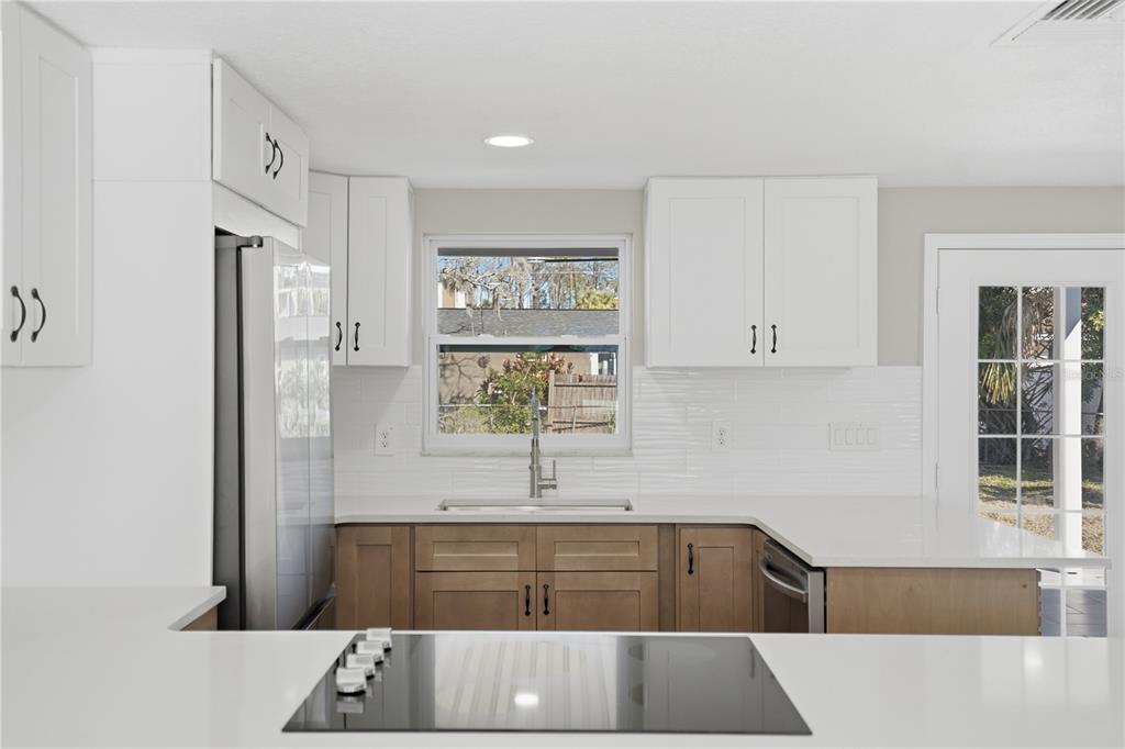 5543 Quist Drive Port Richey, FL 34668 - Photo 7 of 21 a kitchen with a refrigerator and sink
