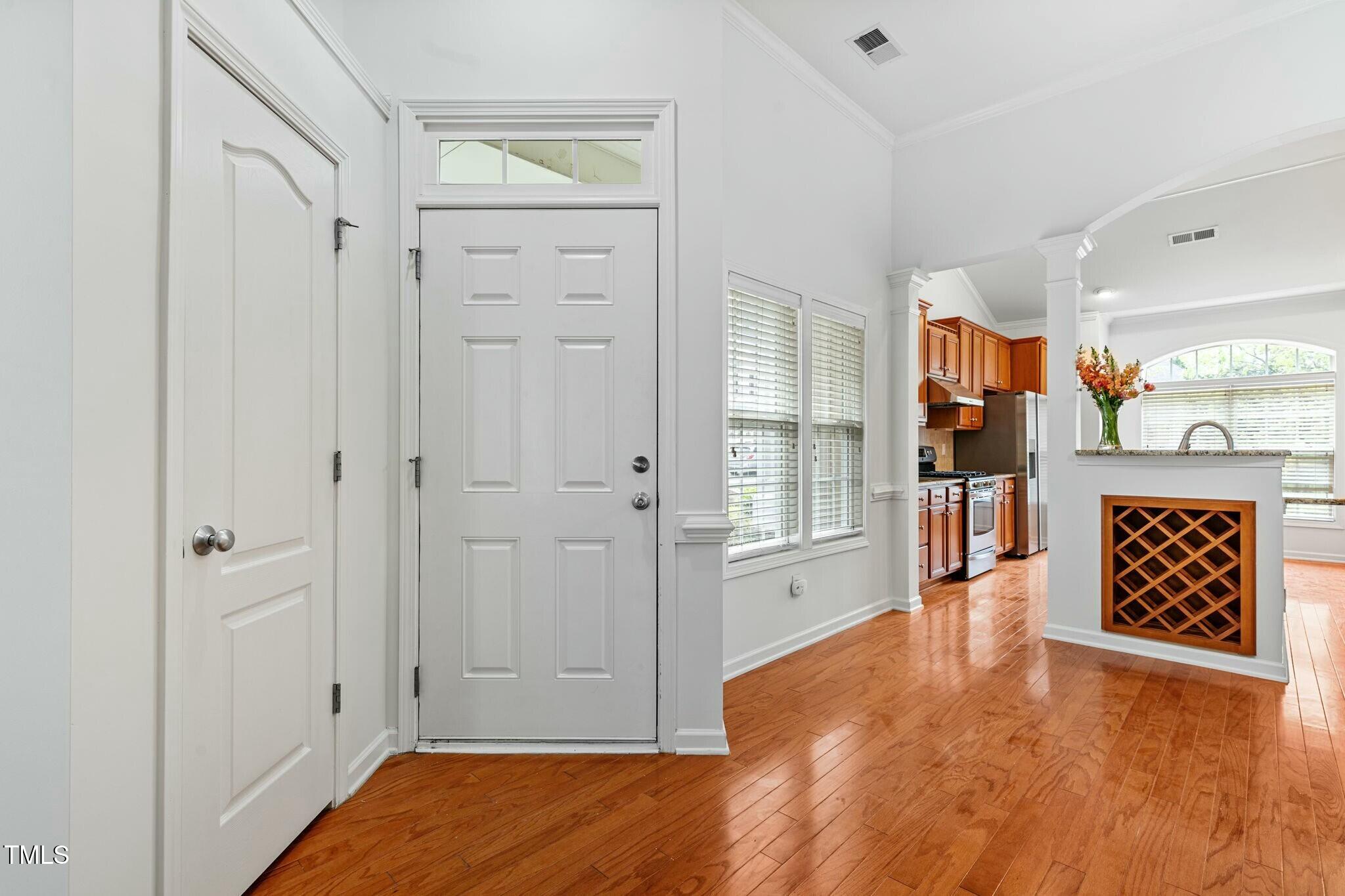 13338 Ashford Park Drive Raleigh, NC 27613 - Photo 10 of 44 a view of a hallway with wooden floor and a cabinet