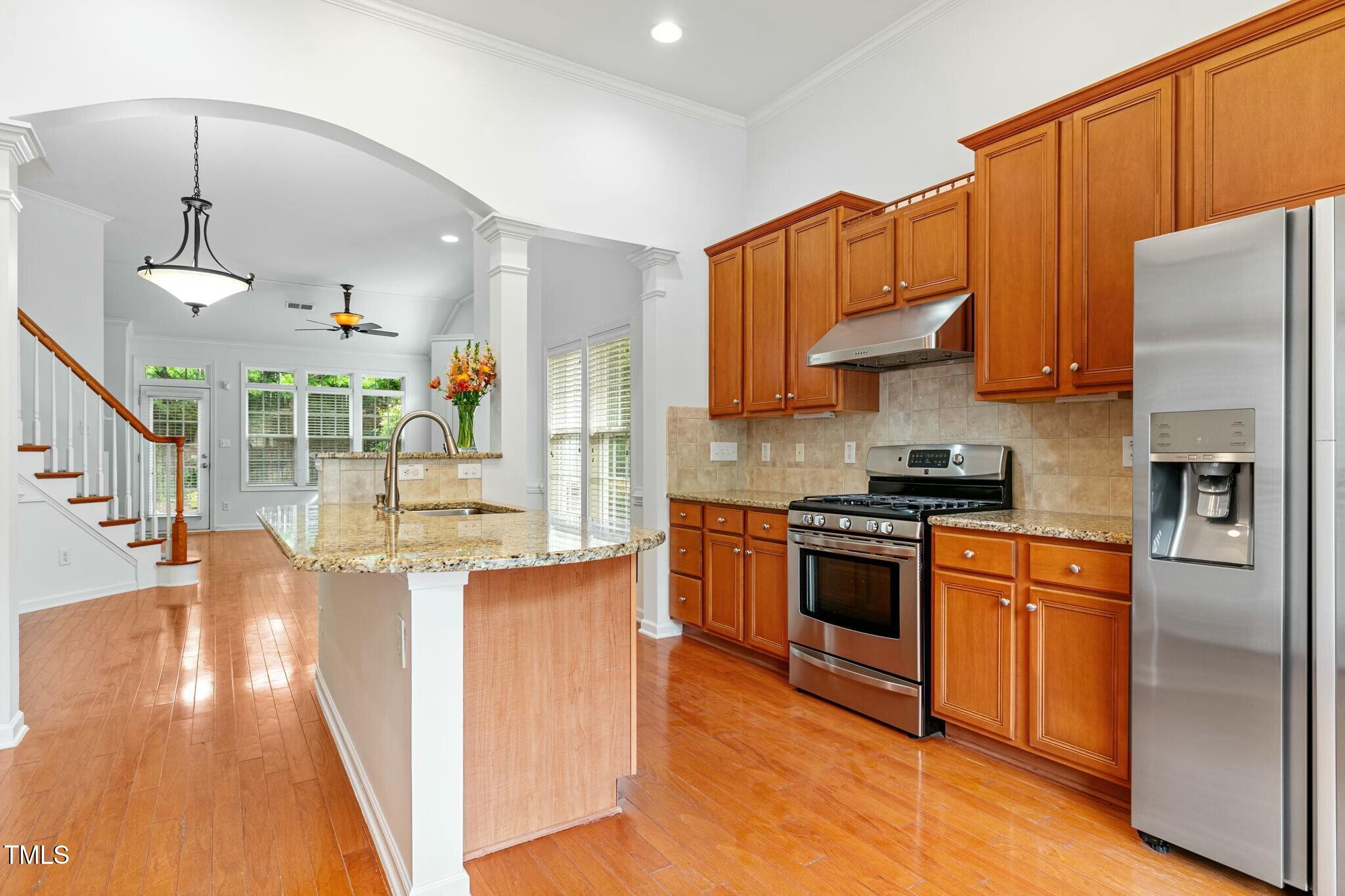 13338 Ashford Park Drive Raleigh, NC 27613 - Photo 12 of 44 a kitchen with stainless steel appliances granite countertop a refrigerator a stove and a sink with dishwasher