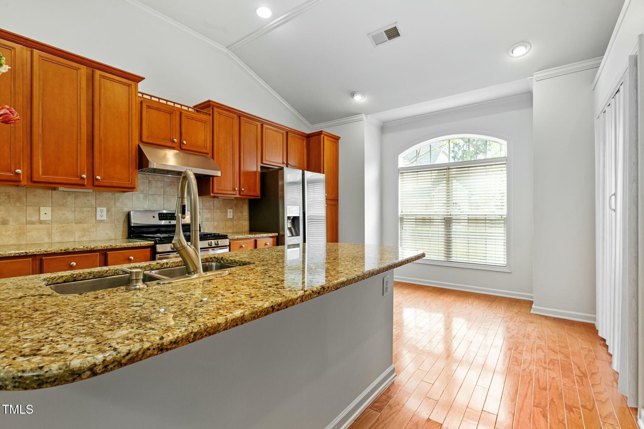 13338 Ashford Park Drive Raleigh, NC 27613 - Photo 14 of 44 a kitchen with a large window appliances and cabinets