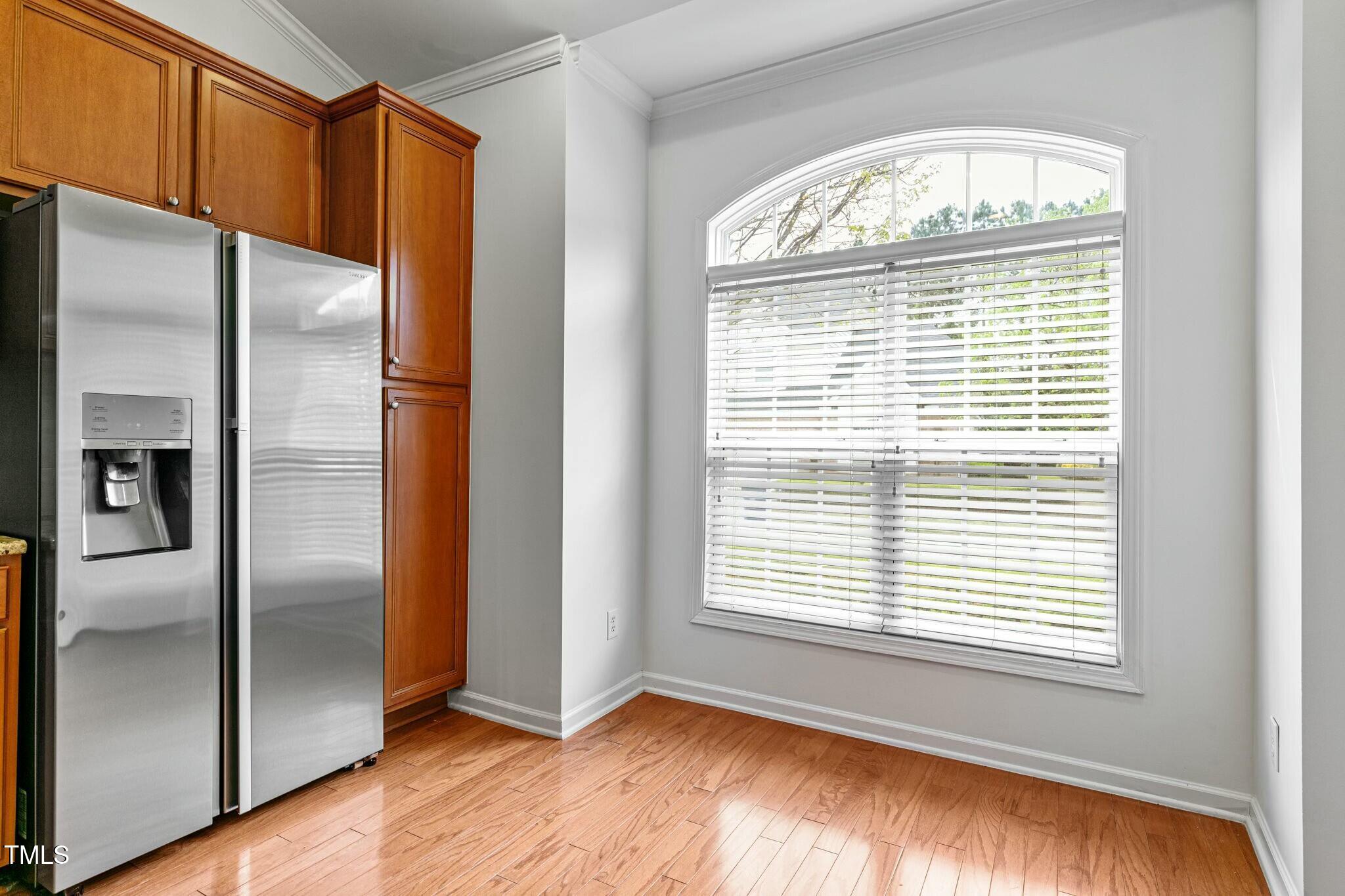 13338 Ashford Park Drive Raleigh, NC 27613 - Photo 16 of 44 a view of empty room with wooden floor and fan