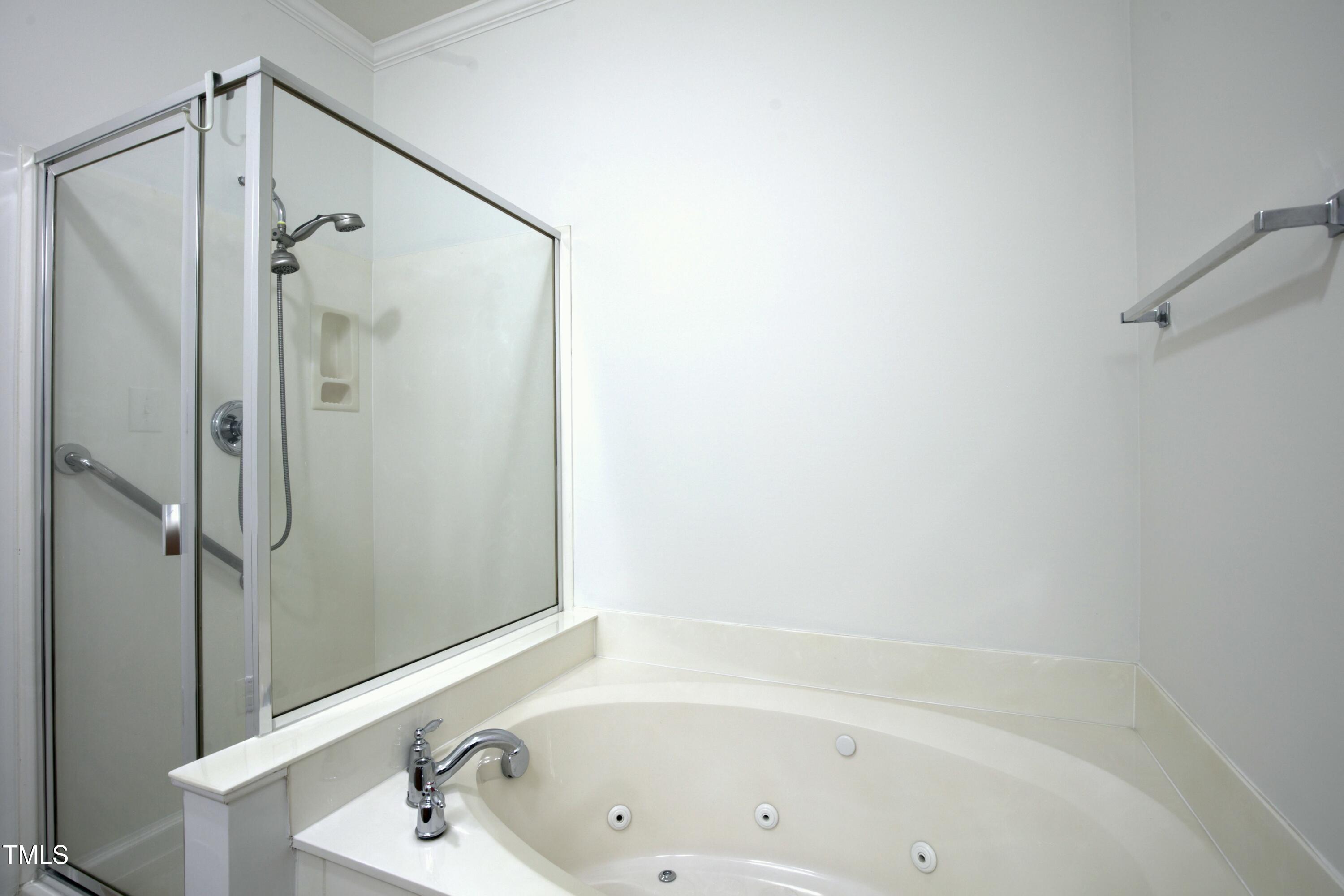 13338 Ashford Park Drive Raleigh, NC 27613 - Photo 22 of 44 a bathroom with a bathtub and a shower