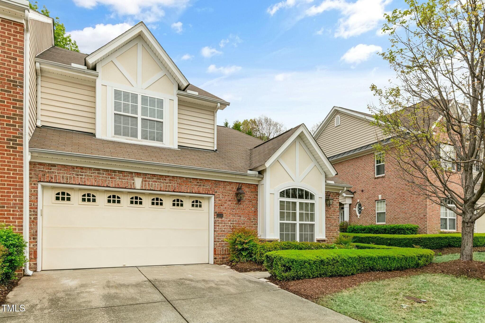 13338 Ashford Park Drive Raleigh, NC 27613 - Photo 2 of 44 a view of a white house with a large windows and flower plants