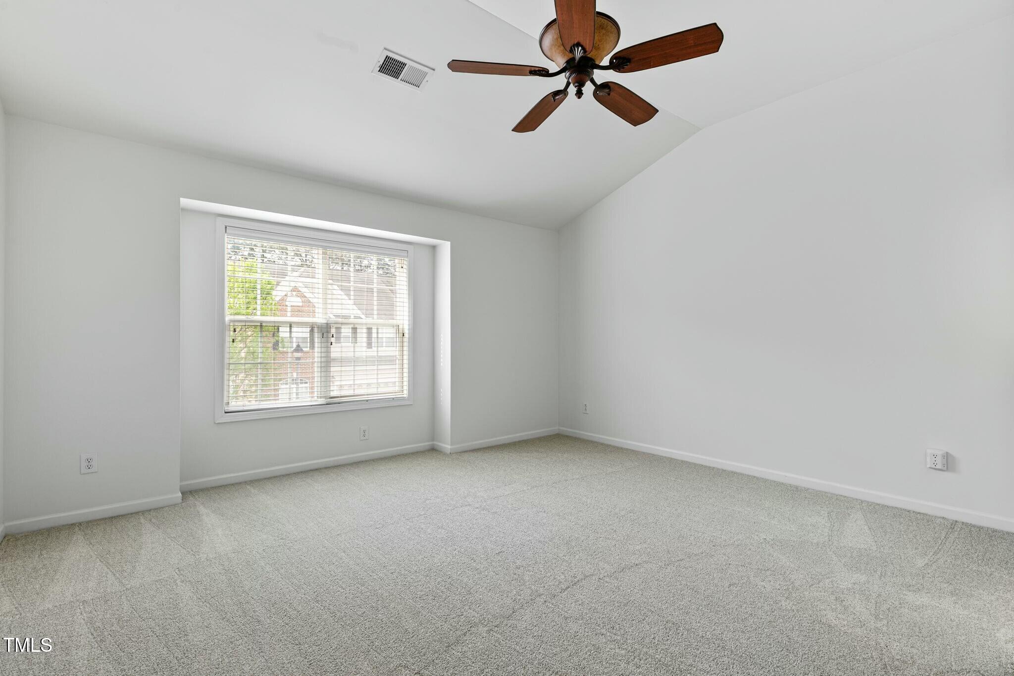 13338 Ashford Park Drive Raleigh, NC 27613 - Photo 30 of 44 an empty room with a window and a fan