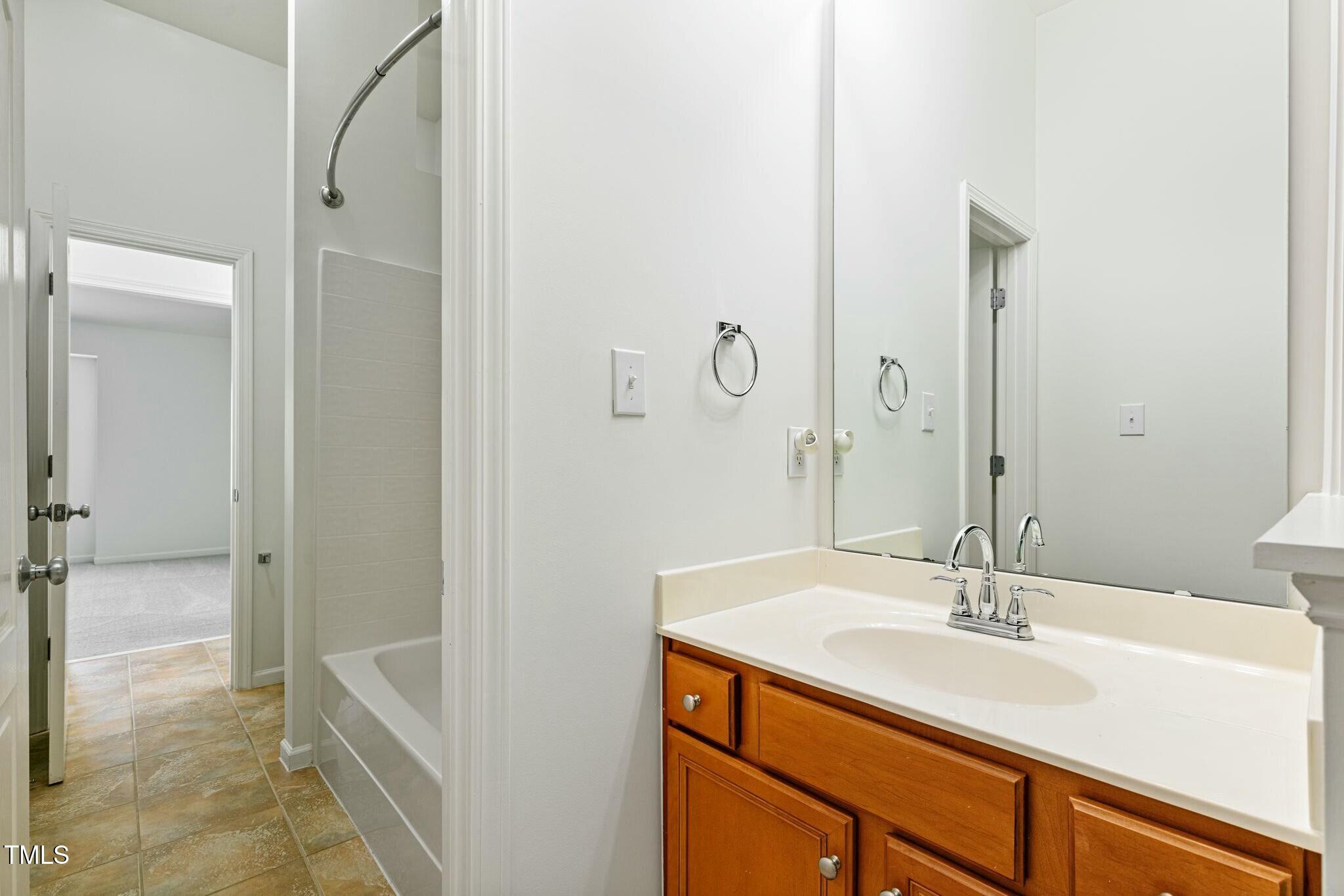 13338 Ashford Park Drive Raleigh, NC 27613 - Photo 32 of 44 a bathroom with a sink and a mirror