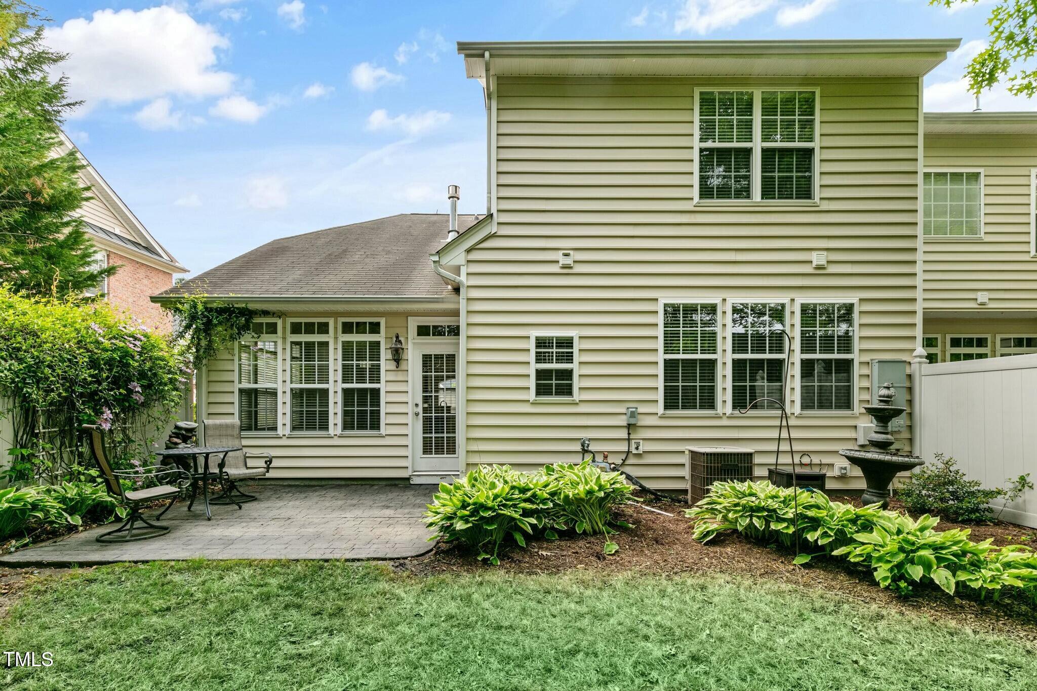 13338 Ashford Park Drive Raleigh, NC 27613 - Photo 38 of 44 a front view of a house with a yard and outdoor seating