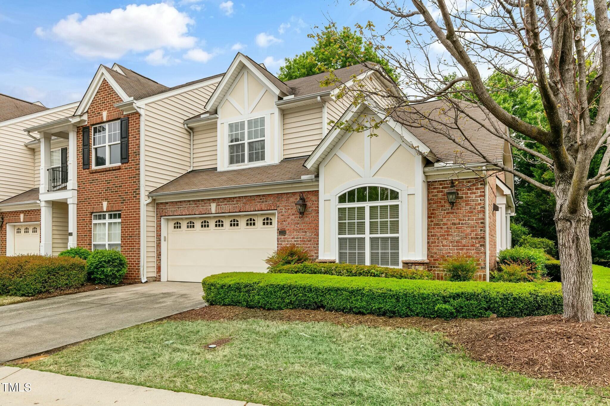 13338 Ashford Park Drive Raleigh, NC 27613 - Photo 3 of 44 a front view of a house with a garden and plants