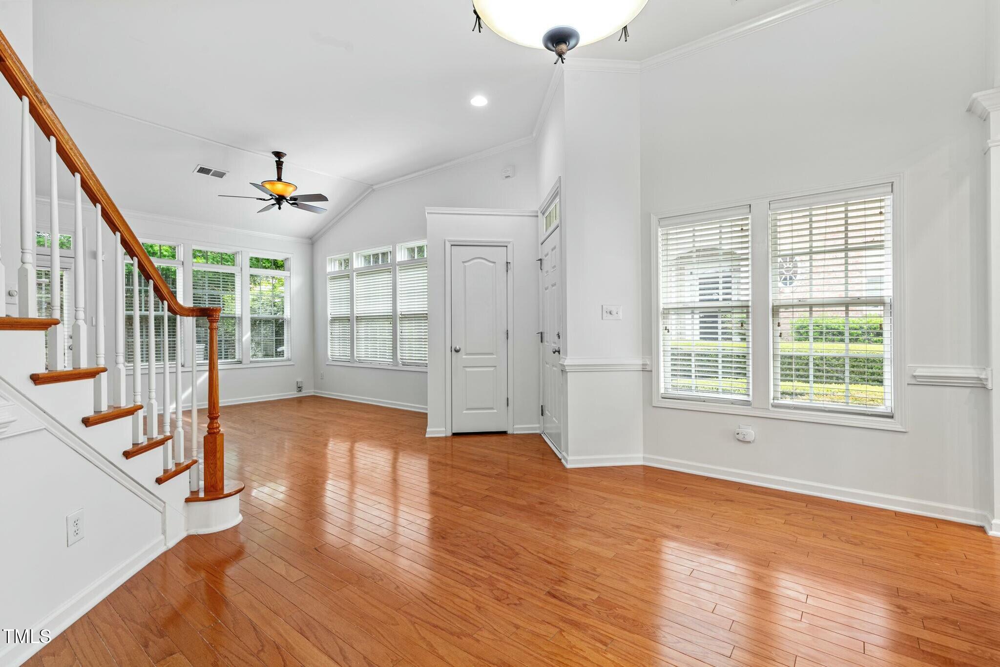 13338 Ashford Park Drive Raleigh, NC 27613 - Photo 7 of 44 an empty room with wooden floor and windows