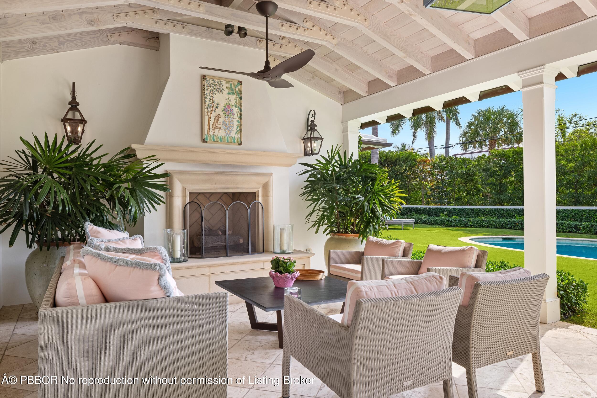 258 List Road Palm Beach, FL 33480 - Photo 37 of 45 a view of a patio with couches table and chairs and potted plants