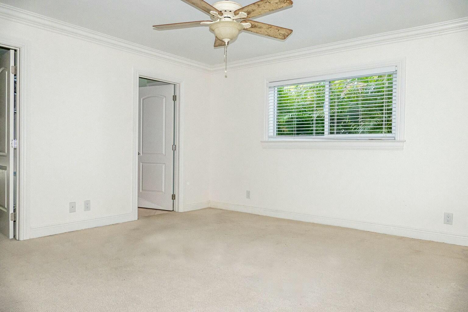 18014 Perigon Way Jupiter, FL 33458 - Photo 15 of 35 an empty room with a window and a fan