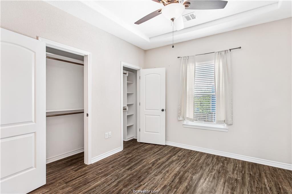 2108 Cavitt Avenue, Unit C Bryan, TX 77801 - Photo 12 of 14 a view of an empty room with wooden floor and a window