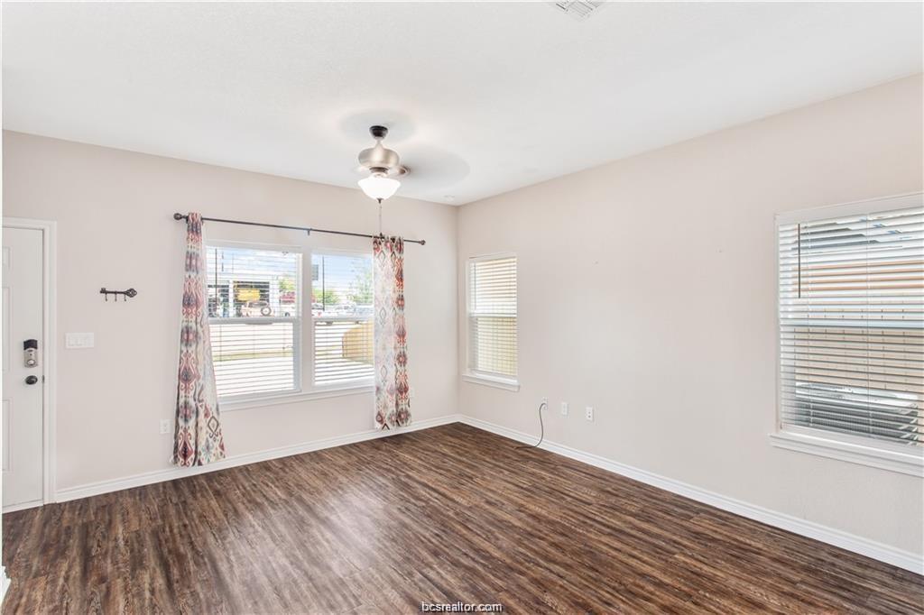 2108 Cavitt Avenue, Unit C Bryan, TX 77801 - Photo 3 of 14 an empty room with wooden floor and windows