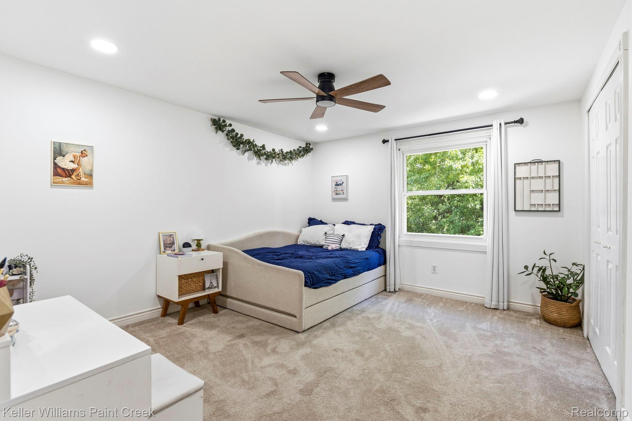 1675 North Kilburn Road Rochester, MI 48306 - Photo 42 of 48 Carpeted room featuring a ceiling fan with integrated lighting, recessed ceiling lights, a large window with white trim, and bi-fold closet doors