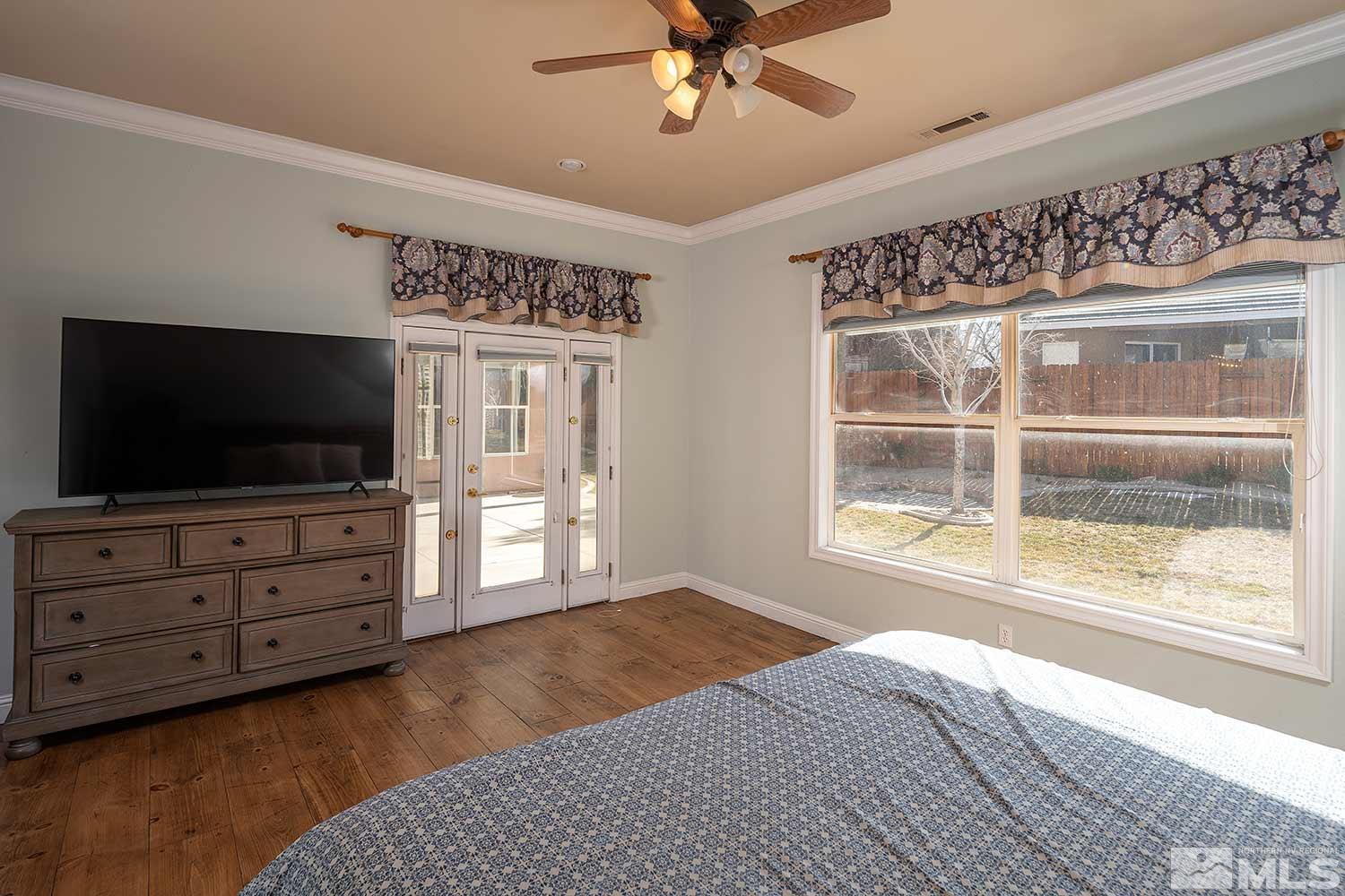 9785 Rolling Rock Court Reno, NV 89521 - Photo 17 of 35 a bedroom with furniture and a flat screen tv