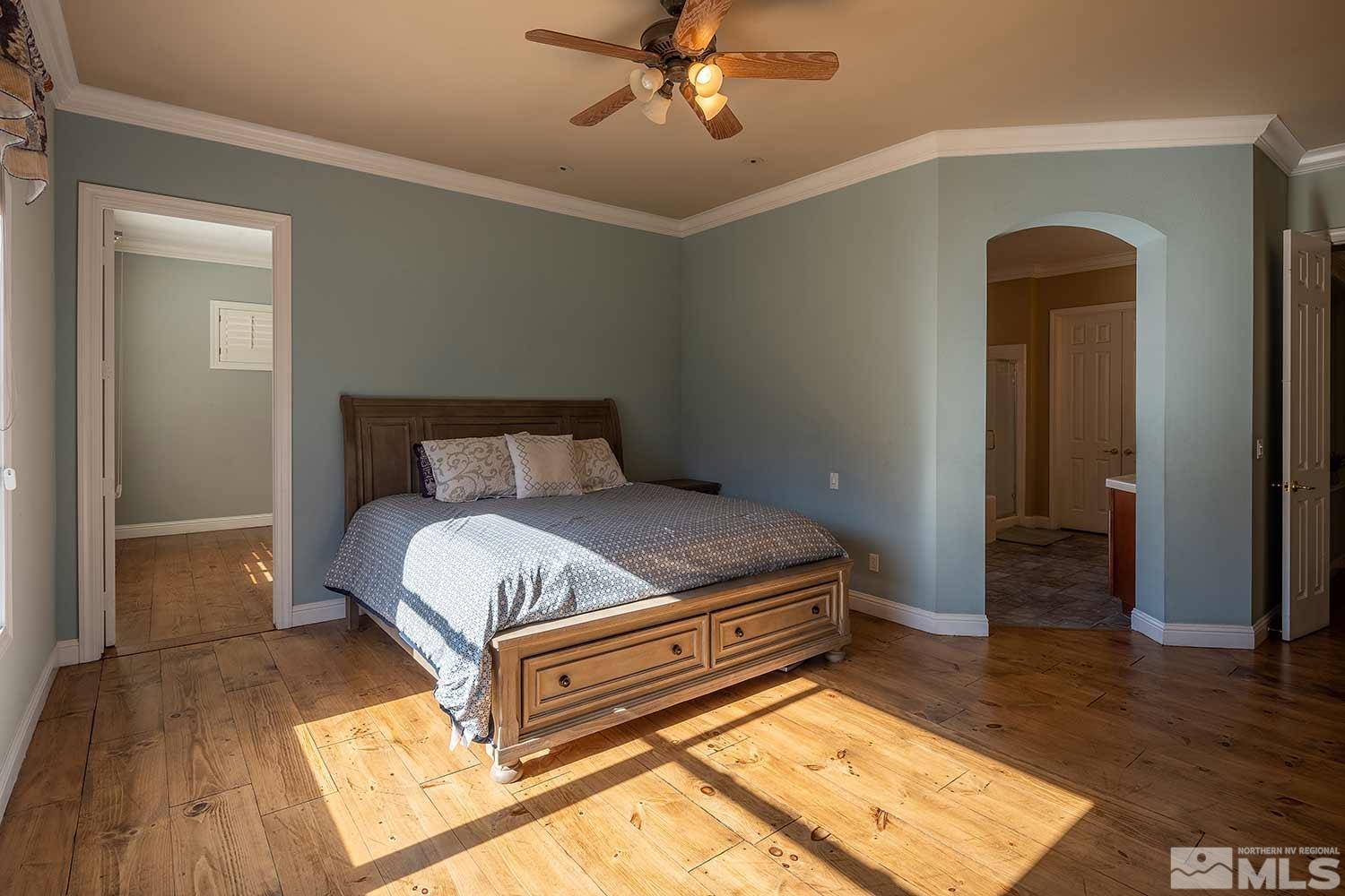 9785 Rolling Rock Court Reno, NV 89521 - Photo 18 of 35 a bedroom with a bed and wooden floor