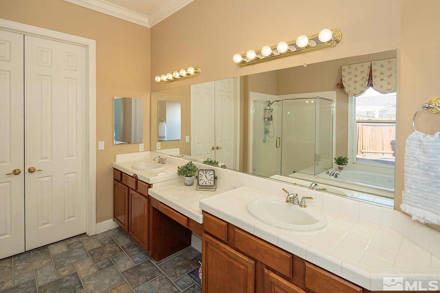 9785 Rolling Rock Court Reno, NV 89521 - Photo 21 of 35 a bathroom with a sink double vanity and a mirror